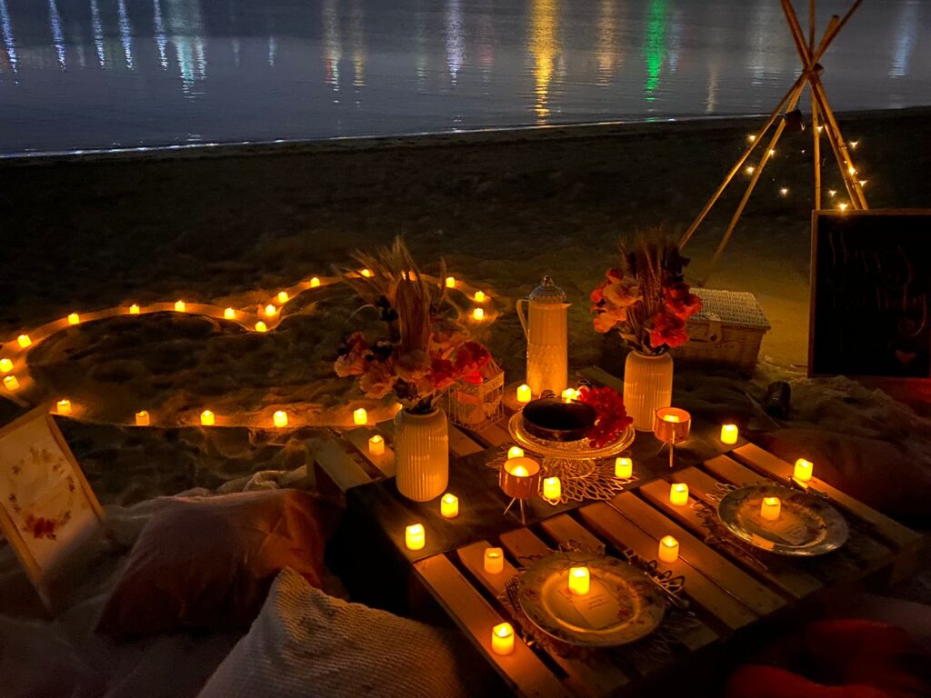 Romantic beach setup in Dubai with heart shaped candles