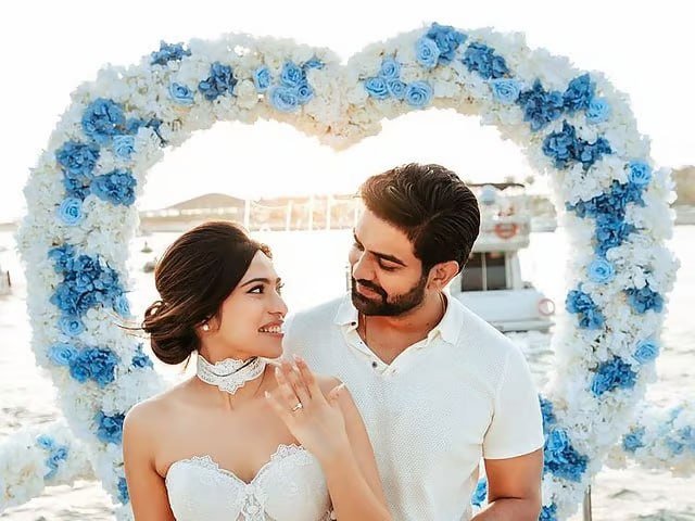 Couple at a floral heart arch by the water — Gulf News feature