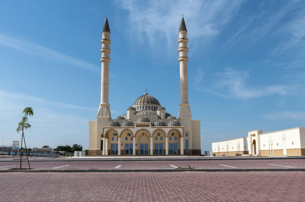 pexels-photo-10723793-10723793 A striking mosque in Umm Al Quwain, showcasing modern Islamic architecture under a clear blue sky.
