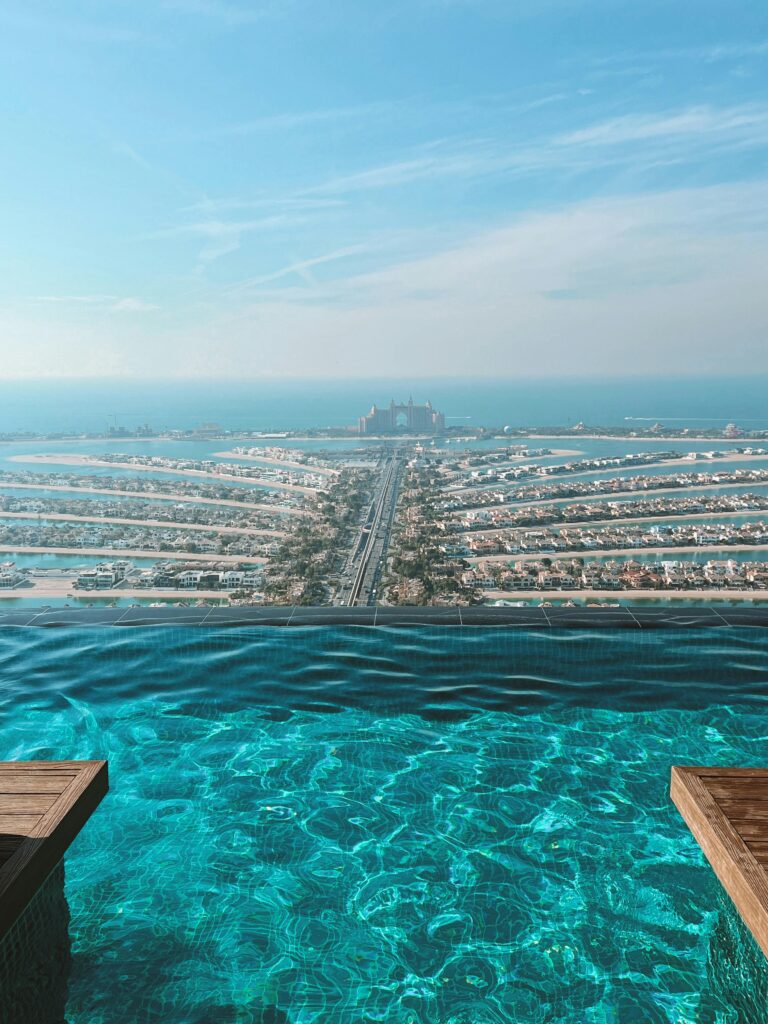 Stunning view of Palm Jumeirah and Atlantis Hotel from a luxury infinity pool in Dubai.