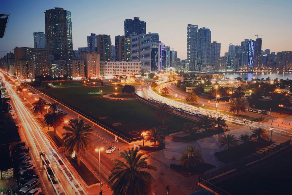 pexels-photo-2864578-2864578 A captivating view of Sharjah cityscape at dusk featuring vibrant light trails and modern skyscrapers.