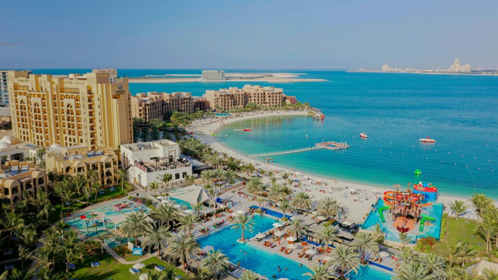 pexels-photo-10484113-10484113 Aerial view of a luxury resort with beach and pool in Ras Al-Khaimah, UAE.